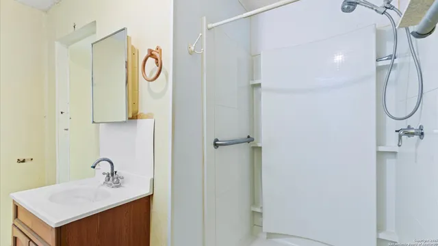 a bathroom with a sink vanity and a mirror