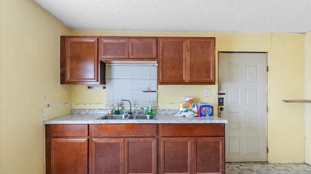 a kitchen with stainless steel appliances granite countertop a sink and cabinets