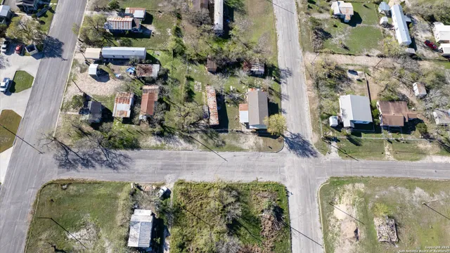 an aerial view of residential houses with outdoor space