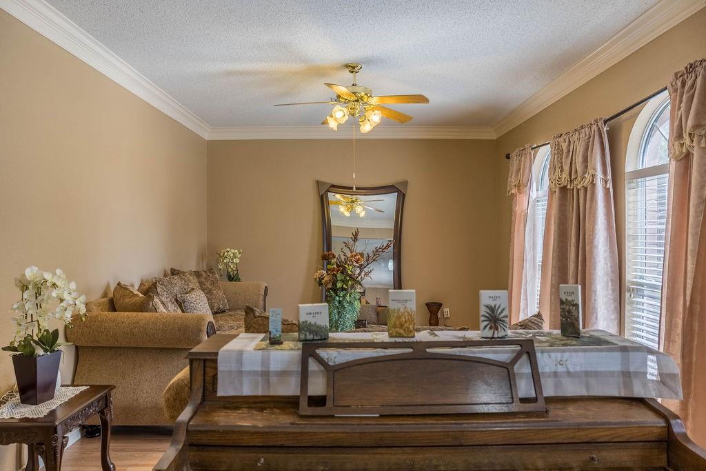 4113 Bluffpoint Road Rowlett, TX 75088 - Photo 7 of 39 a living room with furniture and chandelier