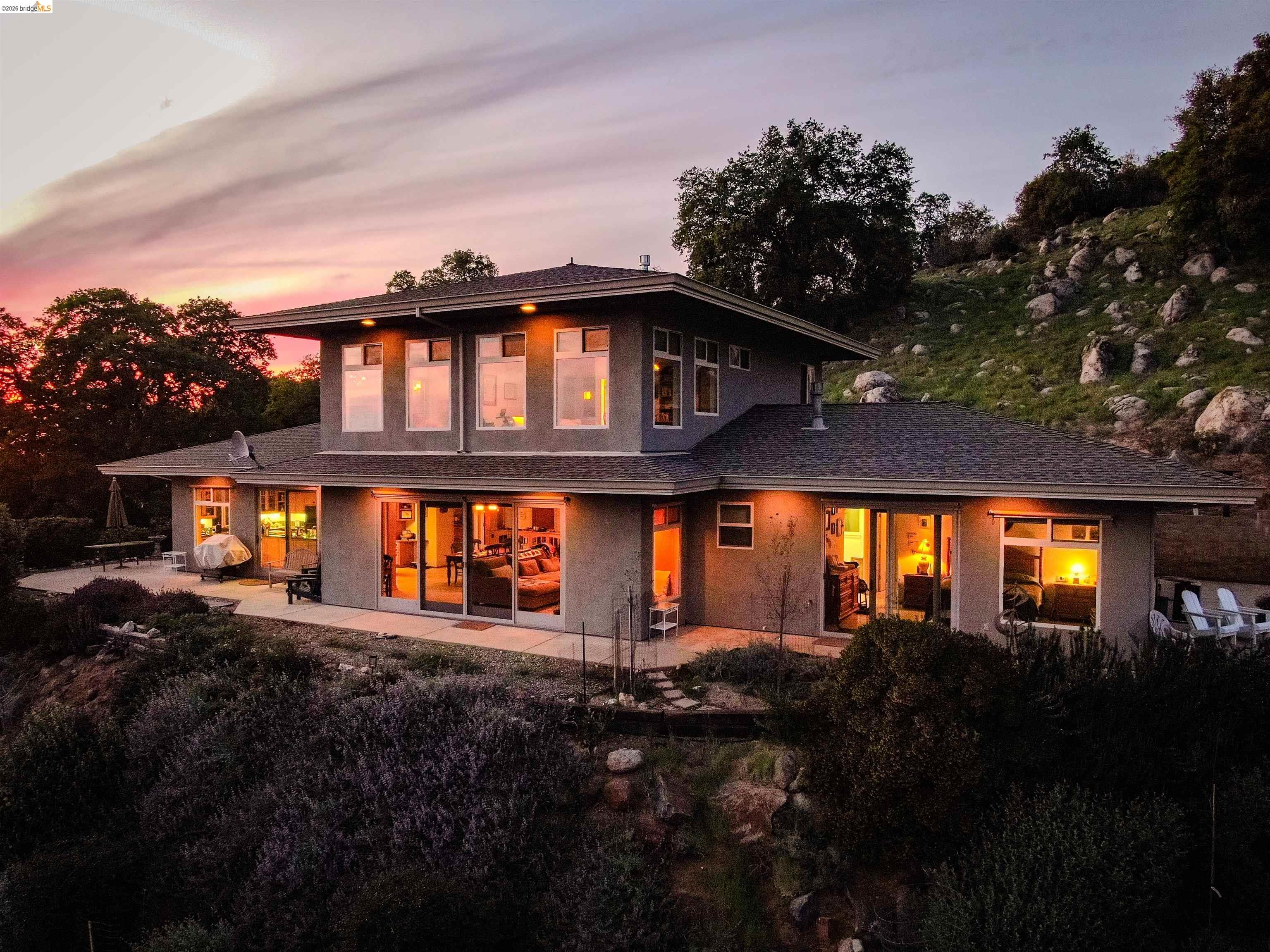 18288 Lambert Lake Road Sonora, CA 95370 - Photo 1 of 55 Front of house featuring stucco siding and a patio