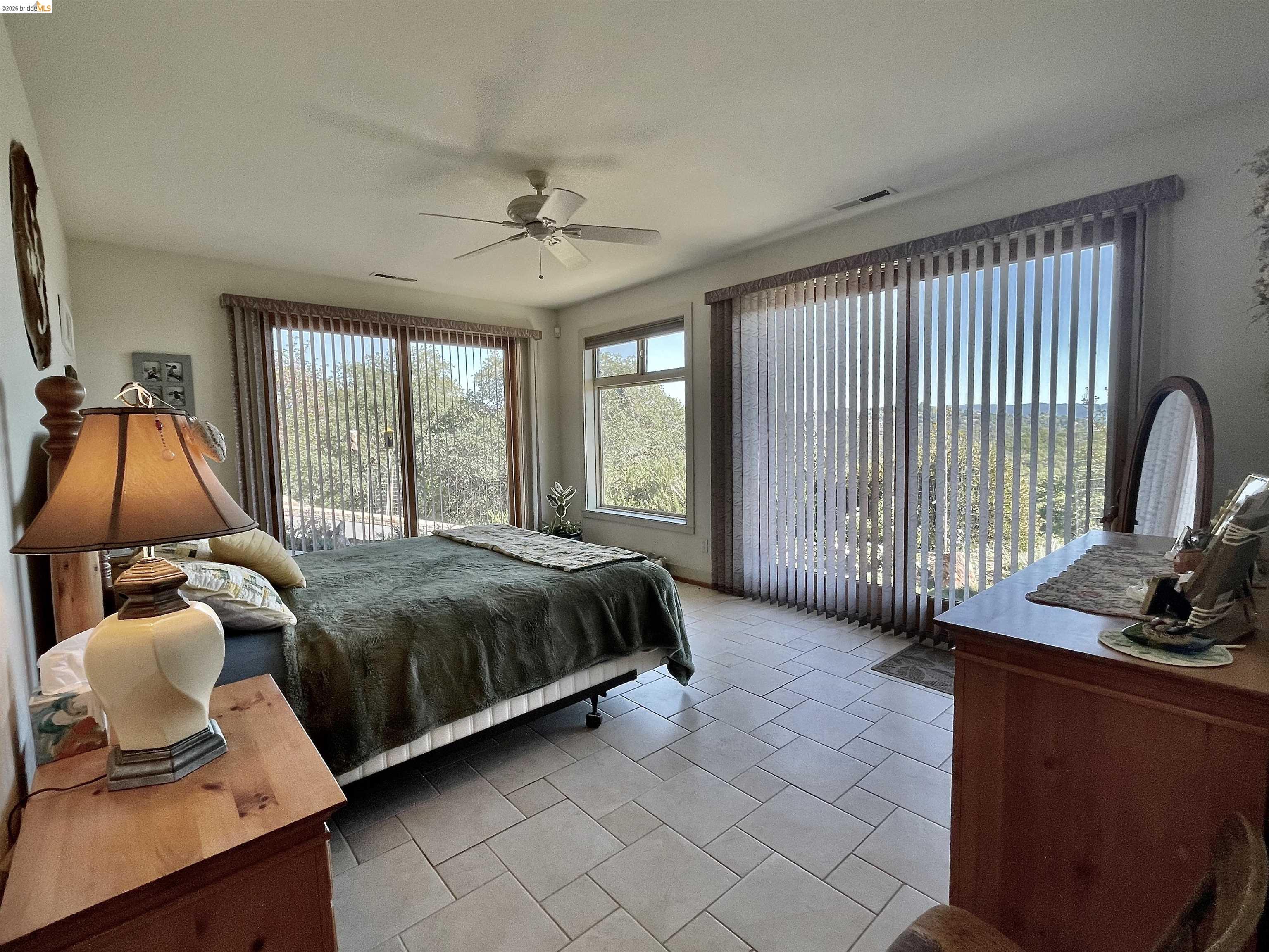 18288 Lambert Lake Road Sonora, CA 95370 - Photo 21 of 55 Bedroom with access to exterior, light tile patterned floors, and ceiling fan