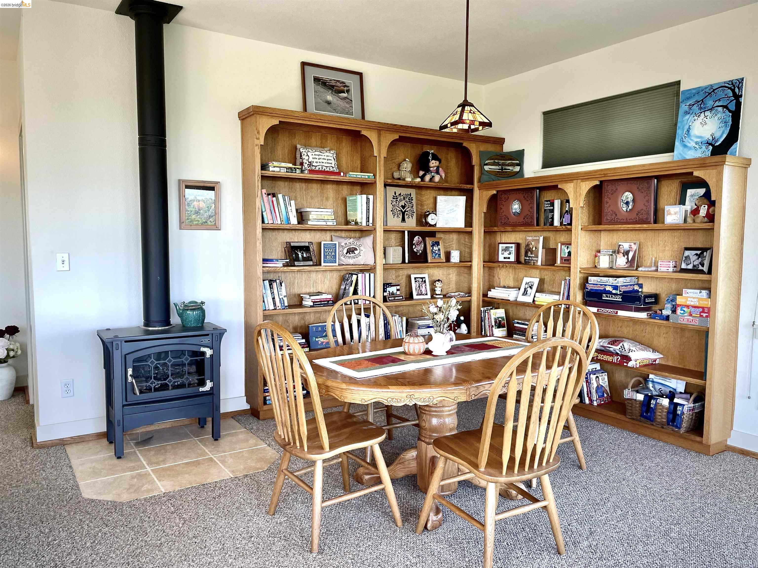 18288 Lambert Lake Road Sonora, CA 95370 - Photo 34 of 55 Dining room featuring light colored carpet and a wood stove