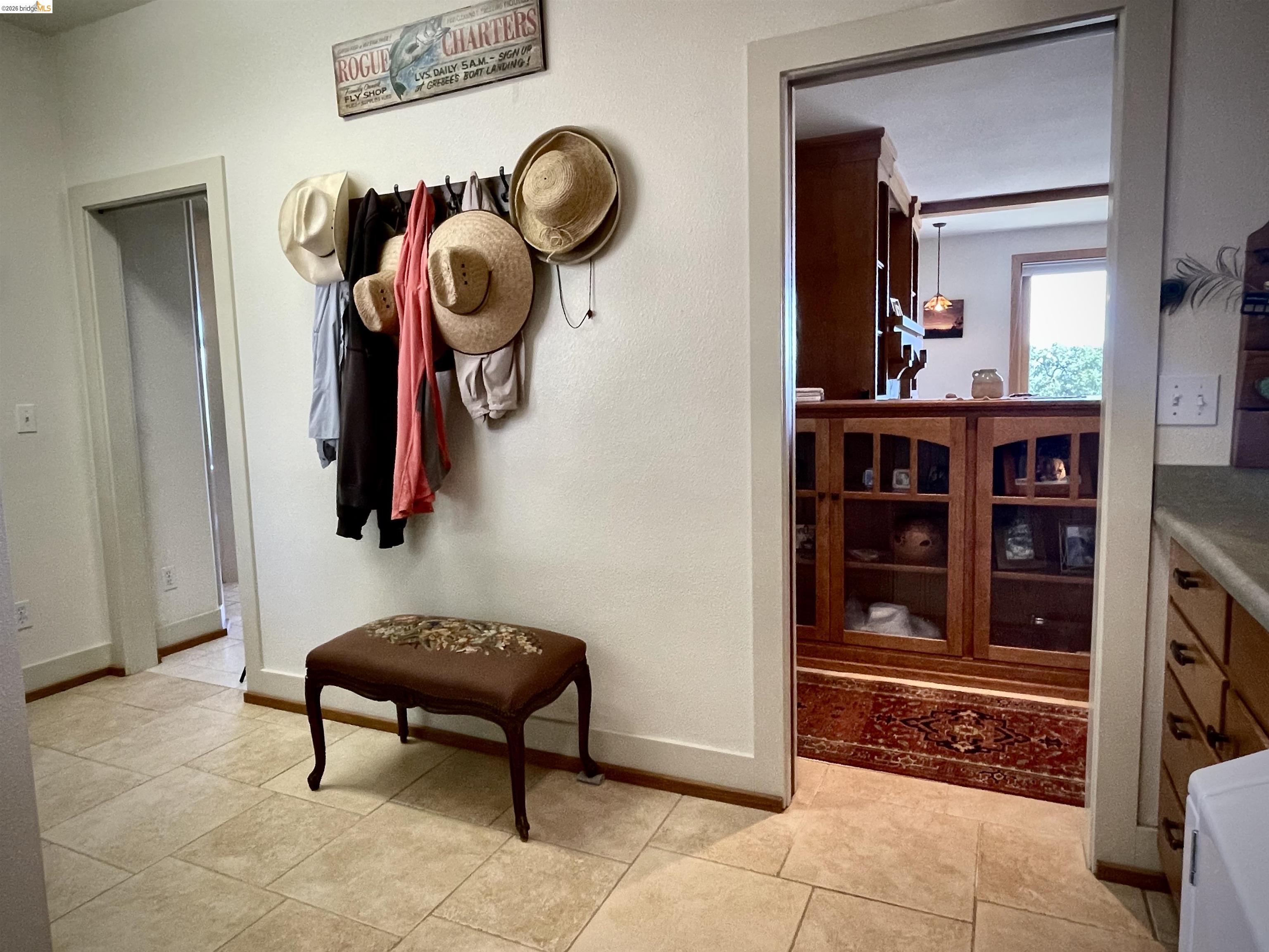 18288 Lambert Lake Road Sonora, CA 95370 - Photo 39 of 55 Corridor featuring light tile patterned flooring and baseboards