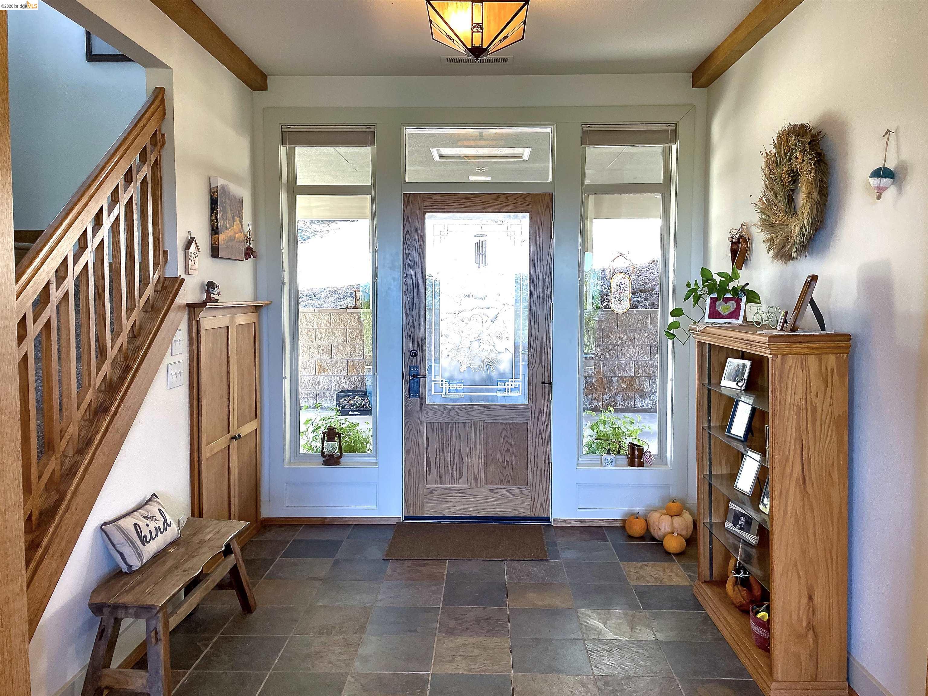 18288 Lambert Lake Road Sonora, CA 95370 - Photo 40 of 55 Foyer entrance featuring stairway and dark stone finish flooring