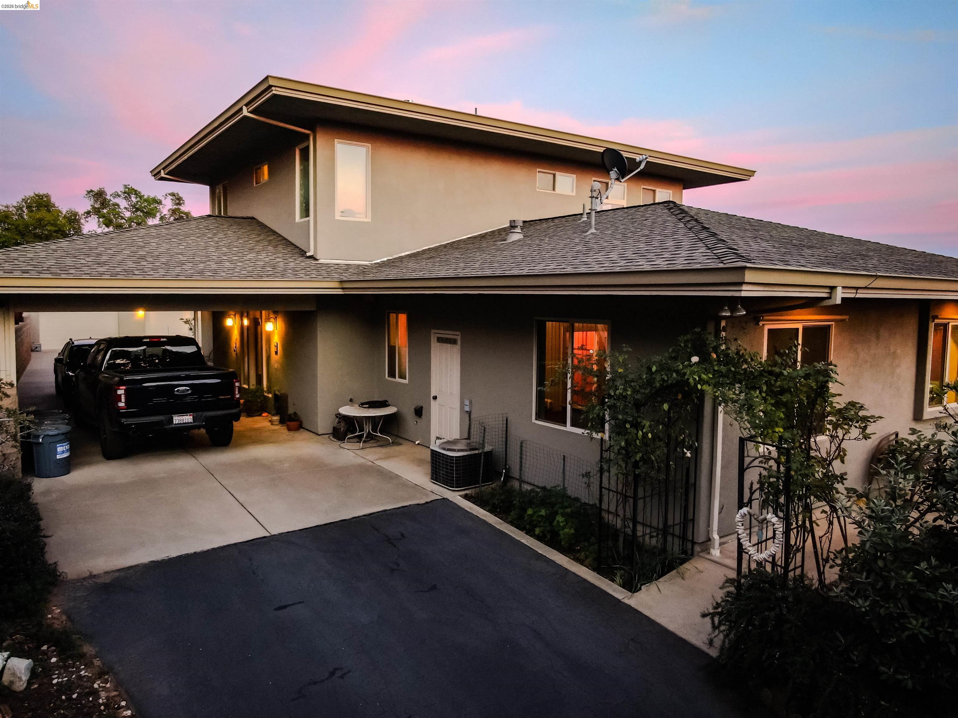 18288 Lambert Lake Road Sonora, CA 95370 - Photo 46 of 55 View of front of property with driveway, stucco siding, a shingled roof, and an attached garage