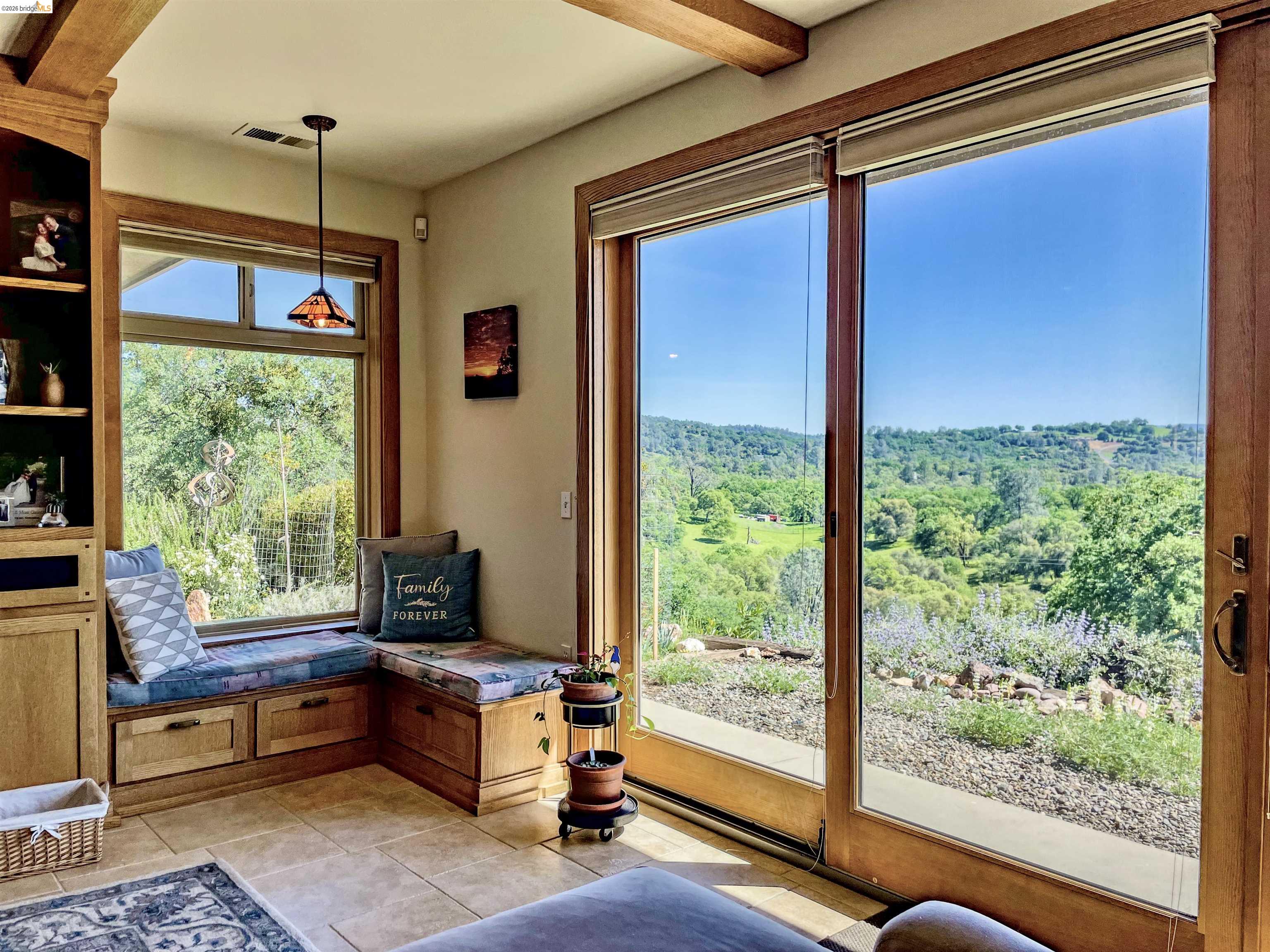 18288 Lambert Lake Road Sonora, CA 95370 - Photo 6 of 55 Sitting areea with light tile patterned floors and a forest view