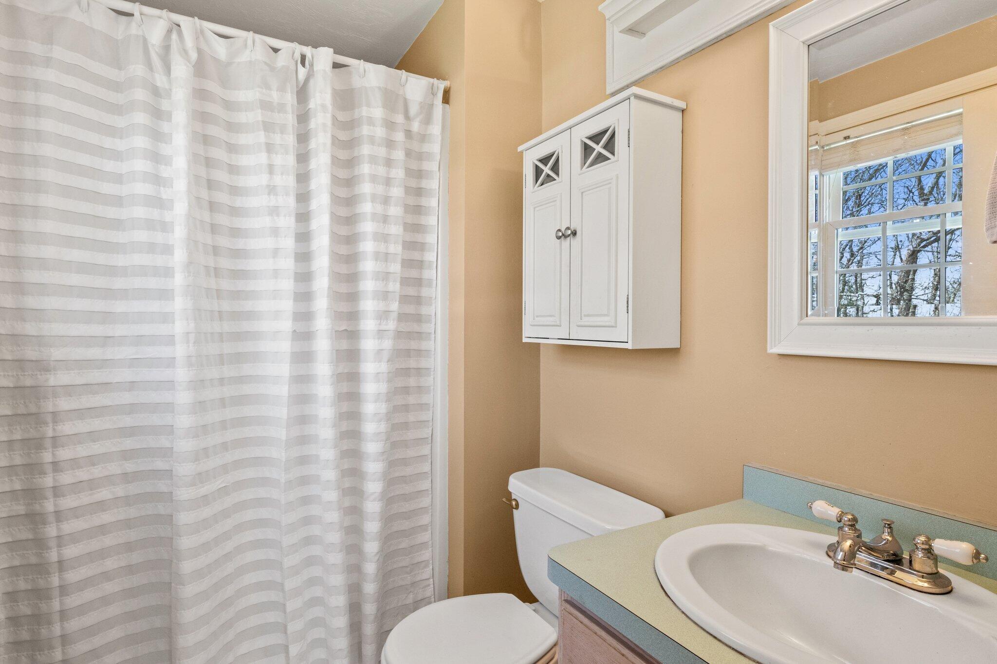9 Forest Road Forestdale, MA 02644 - Photo 17 of 29 a bathroom with a toilet sink and mirror
