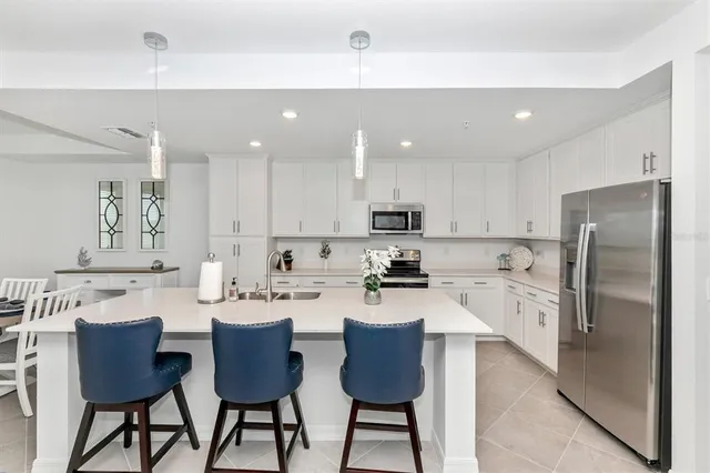 a kitchen with a dining table chairs and view kitchen