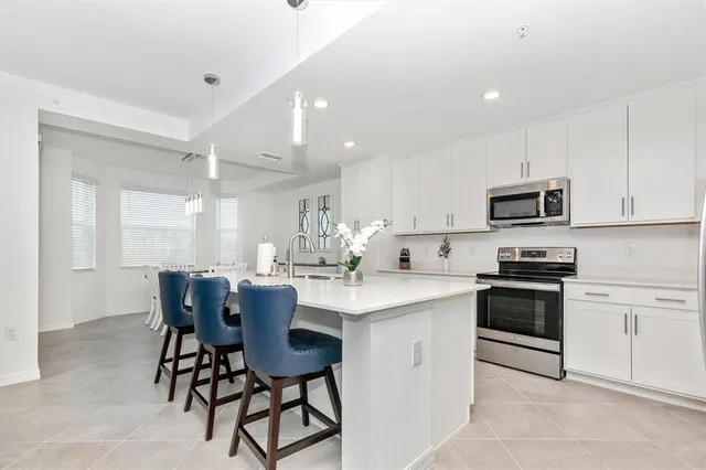 a kitchen with white cabinets and white appliances