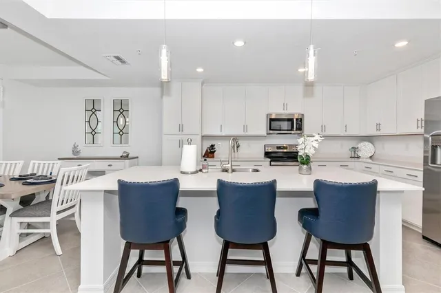 a kitchen with granite countertop white cabinets and white appliances