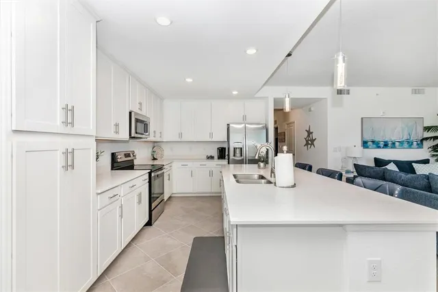a view of a dining room with furniture and chandelier