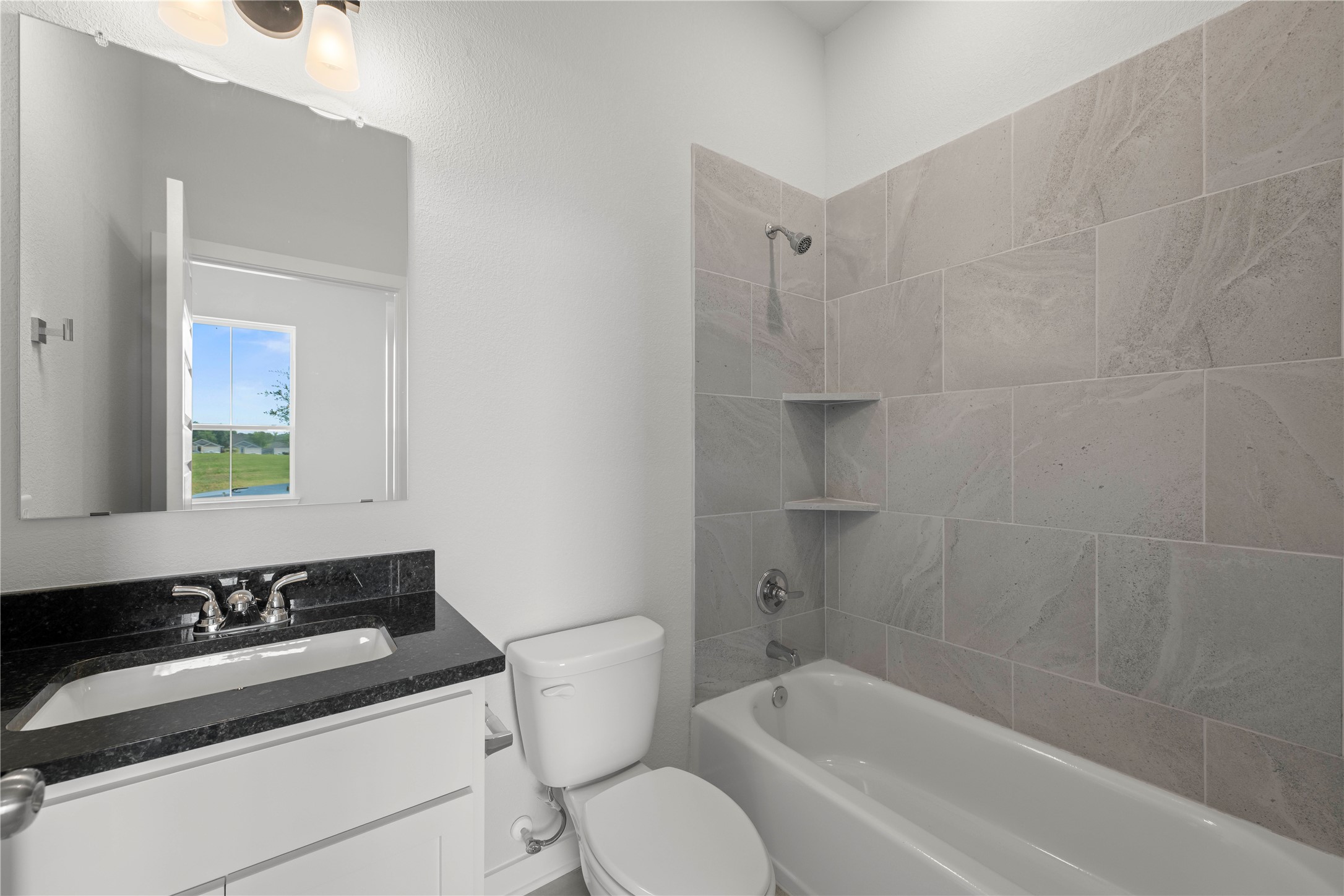 220 Gus Loop Georgetown, TX 78626 - Photo 6 of 18 A well-appointed bathroom with contemporary fixtures and a sleek tiled shower/tub combination.