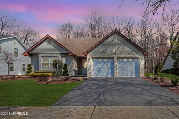 a front view of house with yard and green space