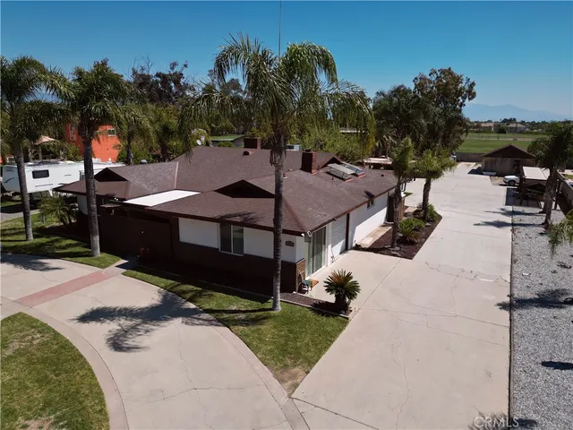 a view of a patio with table and chairs a fire pit and a yard