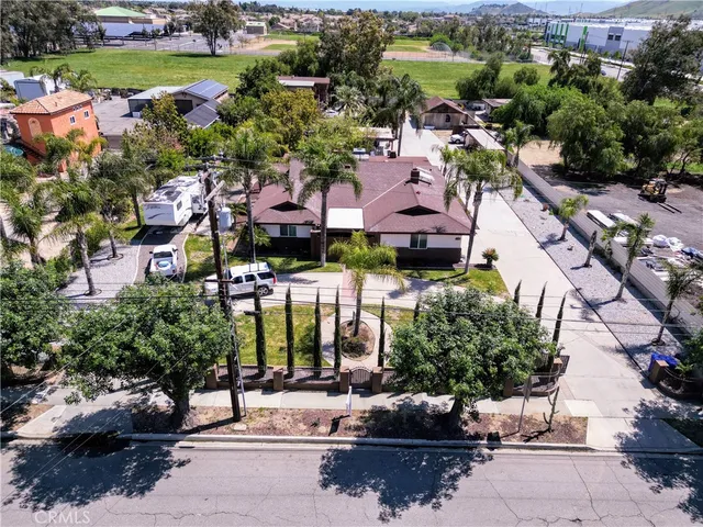 an aerial view of a house with a garden and lake view