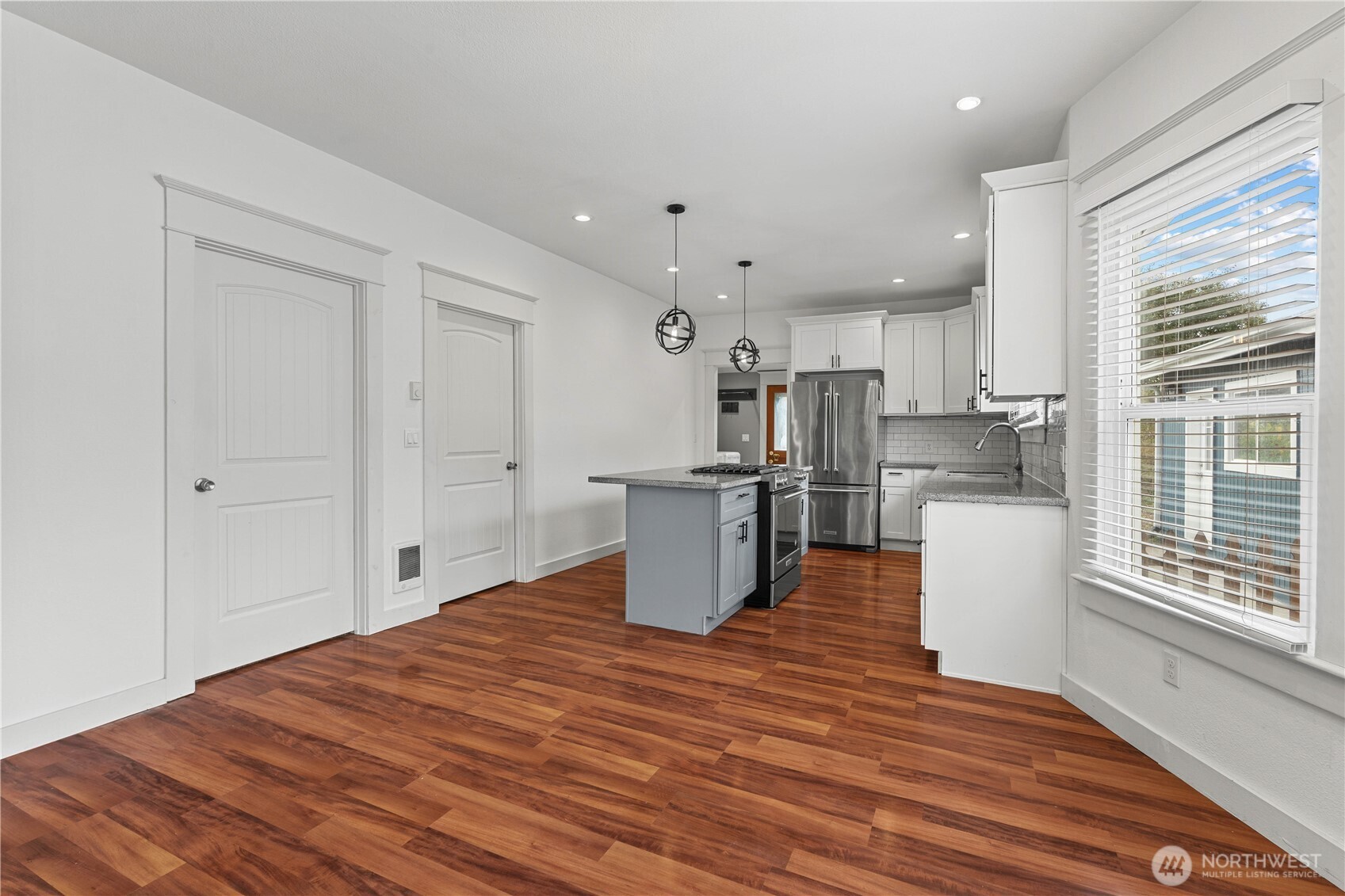 624 West Main Street Sumner, WA 98390 - Photo 11 of 34 a kitchen with stainless steel appliances granite countertop a refrigerator and a stove top oven