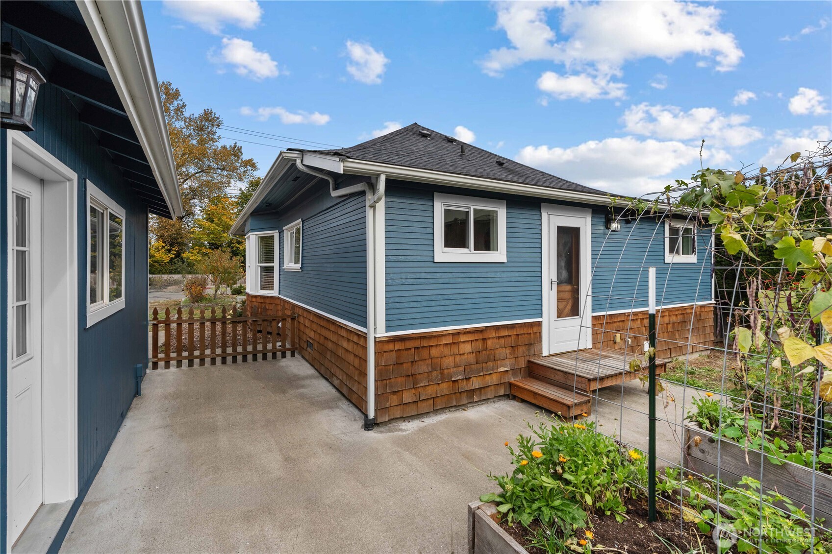 624 West Main Street Sumner, WA 98390 - Photo 20 of 34 a view of a house with a small yard and wooden floor and fence