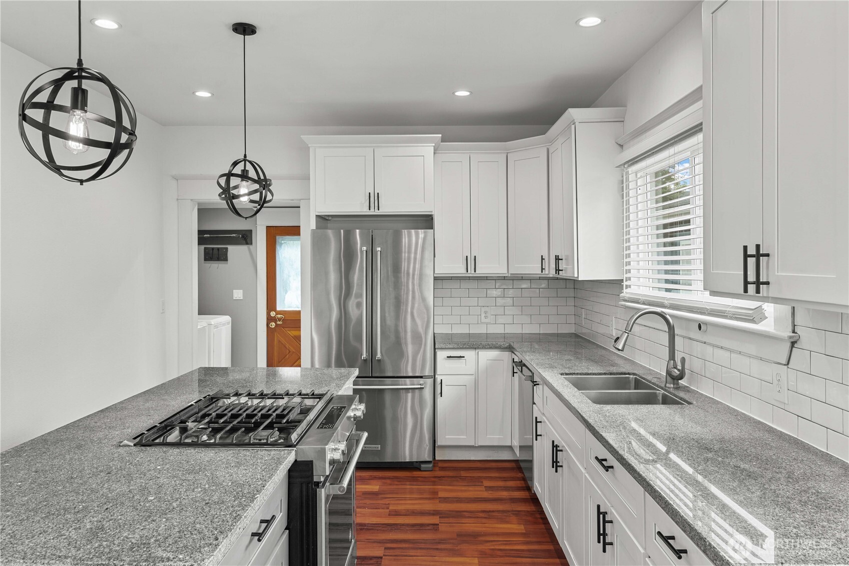 624 West Main Street Sumner, WA 98390 - Photo 9 of 34 a kitchen with stainless steel appliances granite countertop a sink a stove a refrigerator and a window