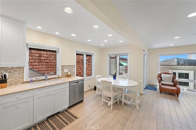 a large white kitchen with a large window