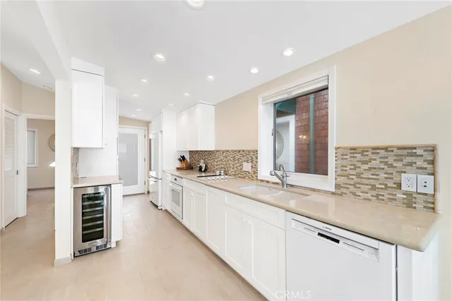 a large kitchen with kitchen island a sink stainless steel appliances and cabinets