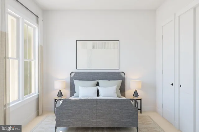 a bed sitting in a bedroom next to a window