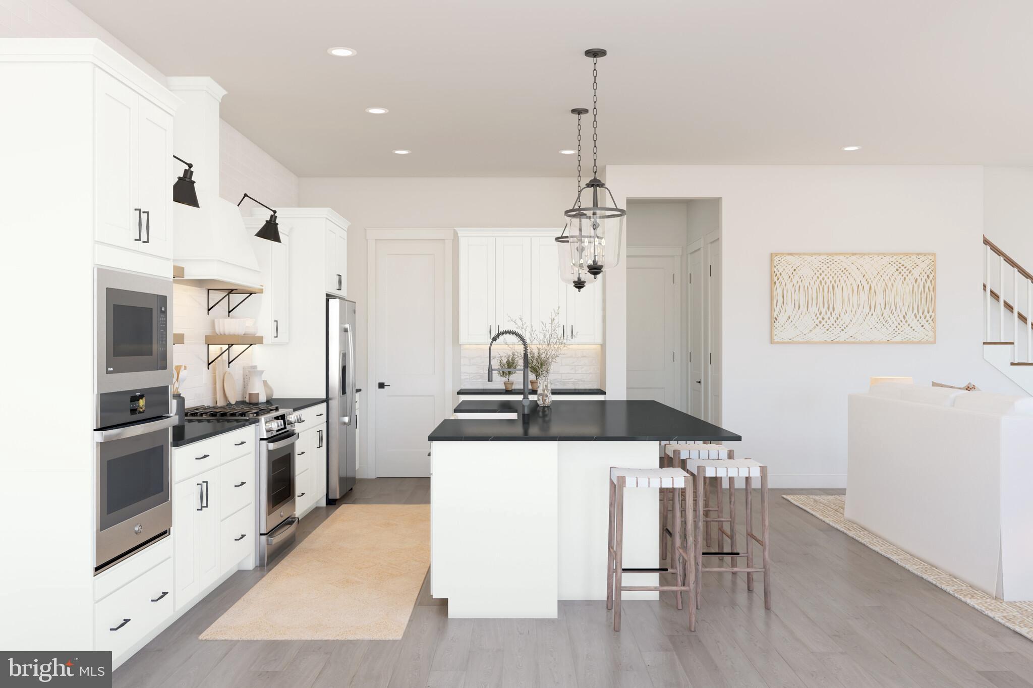 11954 Cygnet Street Lewes, DE 19958 - Photo 4 of 15 a kitchen with stainless steel appliances granite countertop a stove top oven a sink and a refrigerator