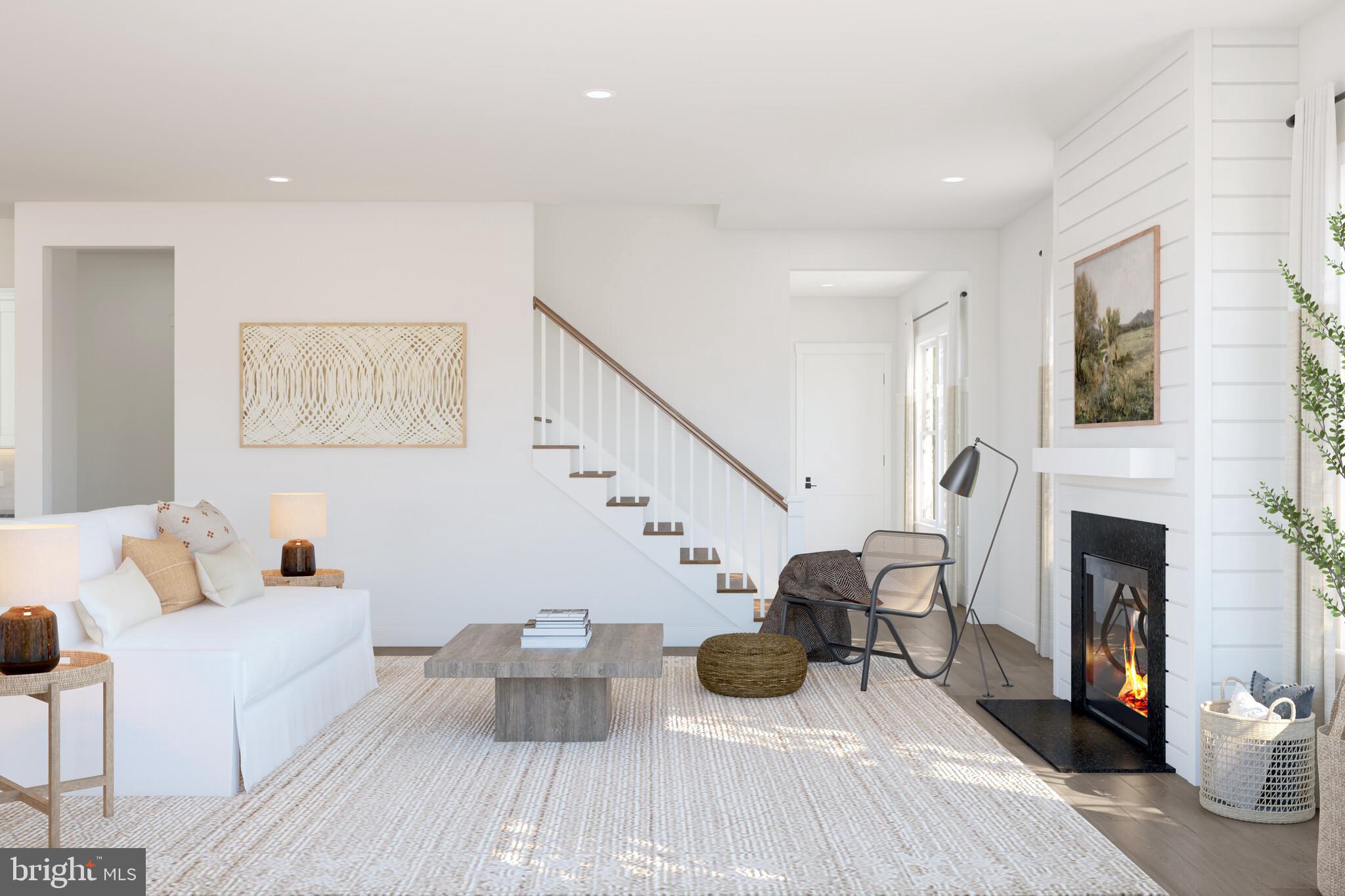 11954 Cygnet Street Lewes, DE 19958 - Photo 8 of 15 a living room with furniture a fireplace and a flat screen tv