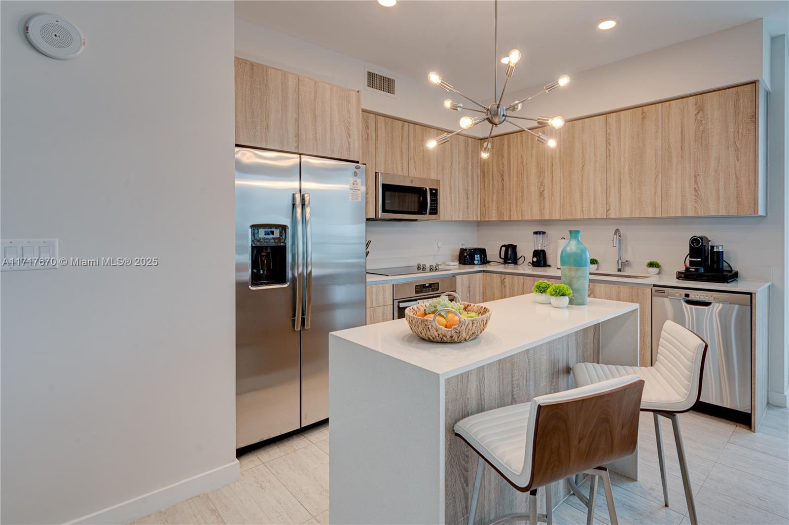 3900 Biscayne Boulevard, Unit N717 Miami, FL 33137 - Photo 15 of 34 a kitchen with a sink cabinets and refrigerator