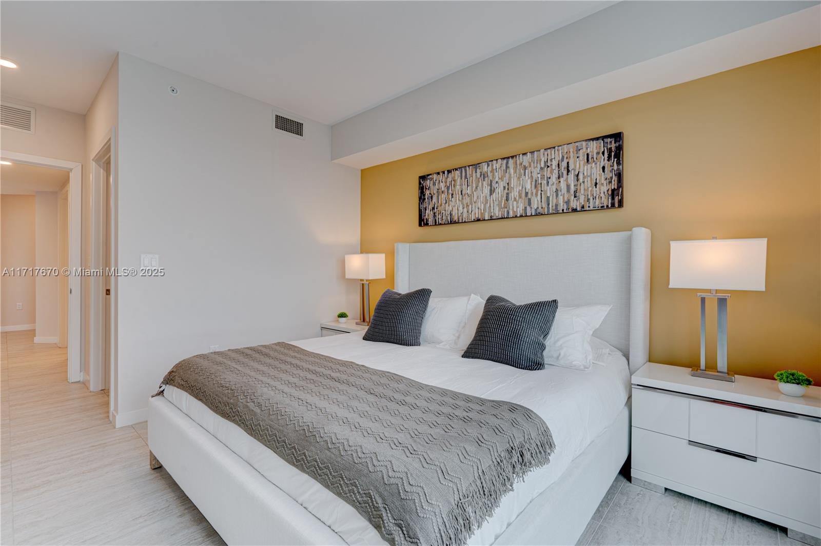 3900 Biscayne Boulevard, Unit N717 Miami, FL 33137 - Photo 16 of 34 a bedroom with a bed and a night stand