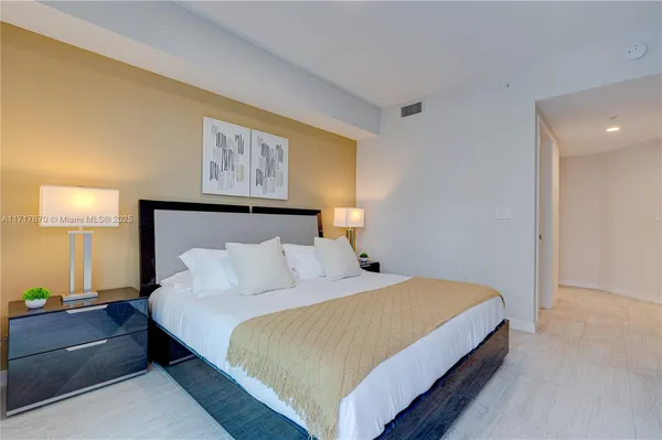 a bedroom with a bed and lamps