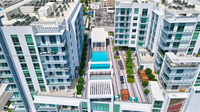 a view of a patio with couches table and chairs and potted plants