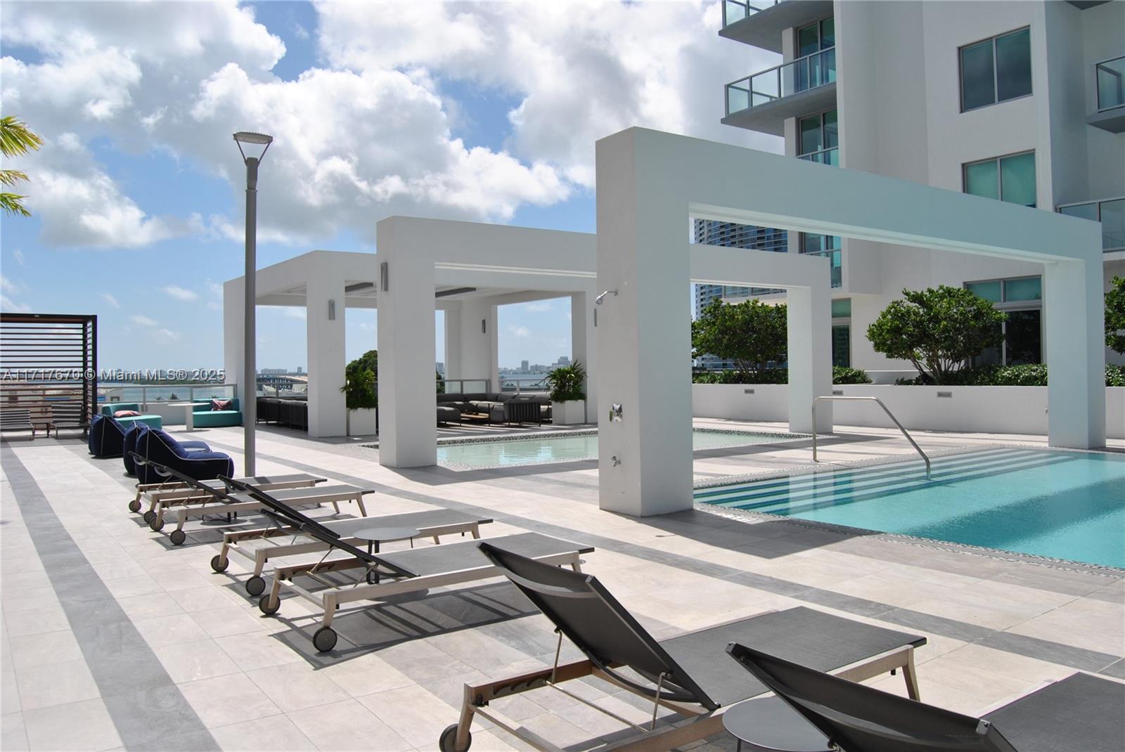 3900 Biscayne Boulevard, Unit N717 Miami, FL 33137 - Photo 26 of 34 a view of a patio with couches table and chairs and potted plants