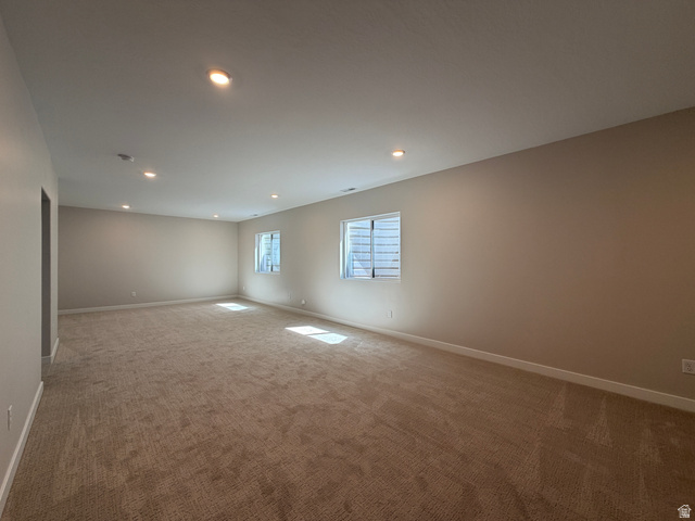 539 East Rimrock Lane Heber City, UT 84032 - Photo 9 of 13 Spacious room with plush carpeting, neutral wall tones, multiple windows, recessed lighting, and white baseboards