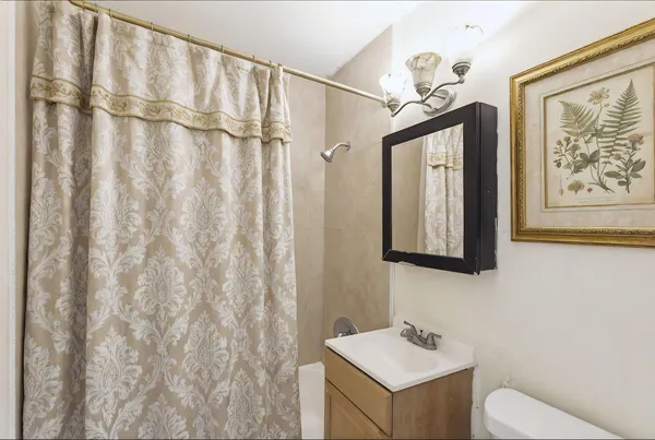 an empty room with fan and windows