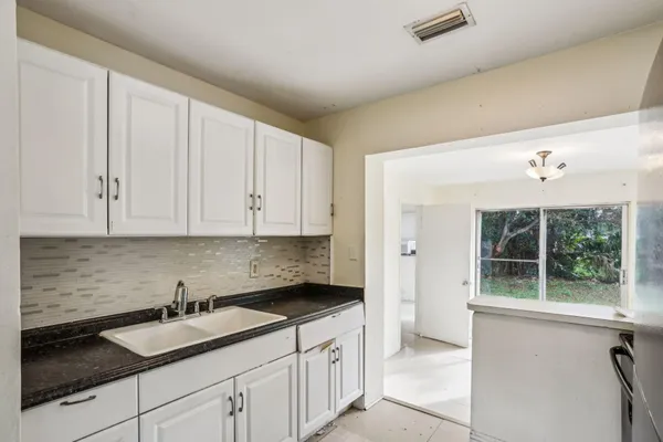 a kitchen with a sink and cabinets
