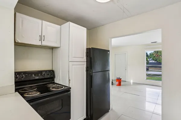a kitchen with a refrigerator and a stove