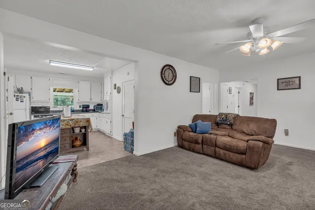 a living room with furniture a chandelier and a couch