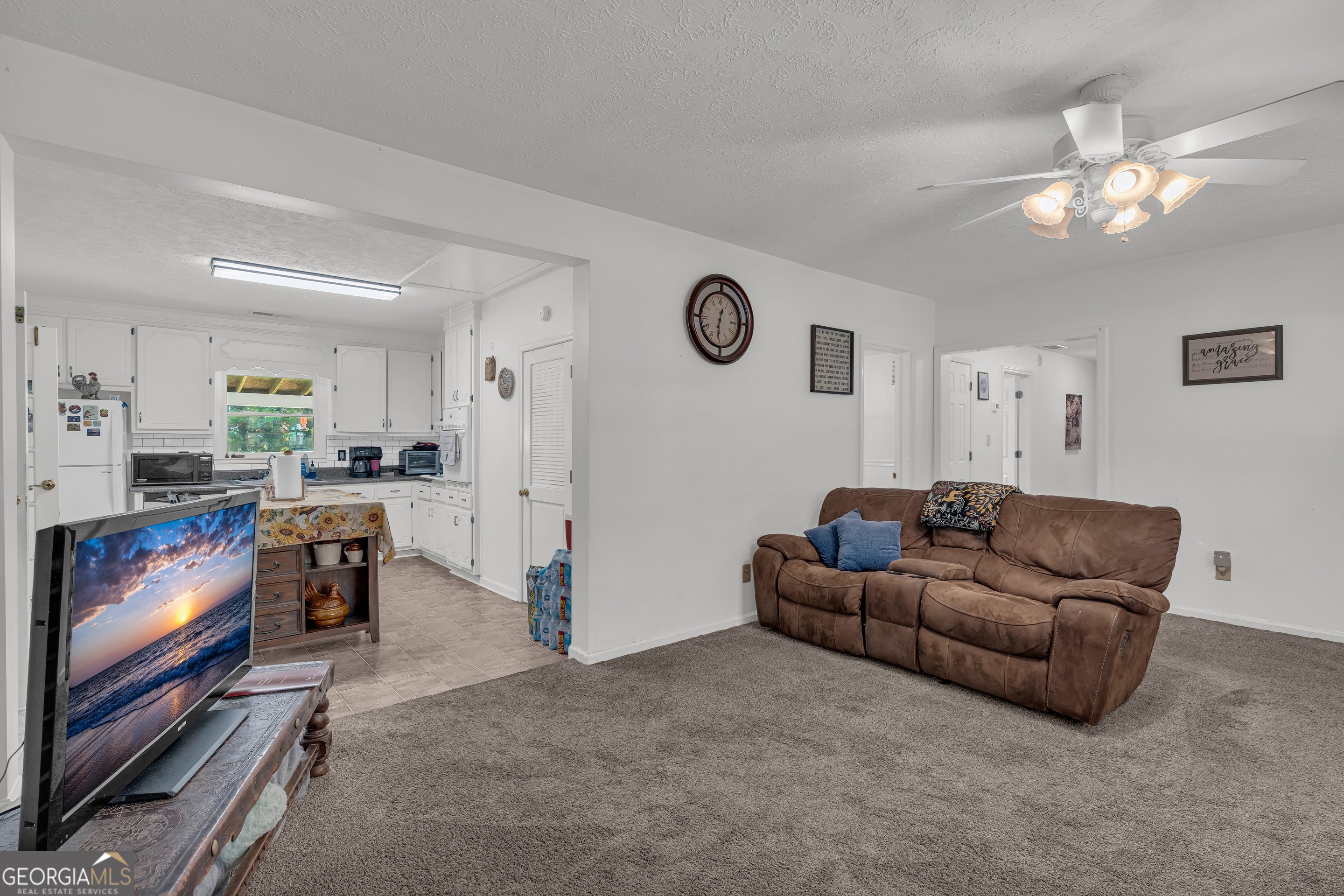 878 Jackson Street Locust Grove, GA 30248 - Photo 14 of 65 a living room with furniture and a flat screen tv