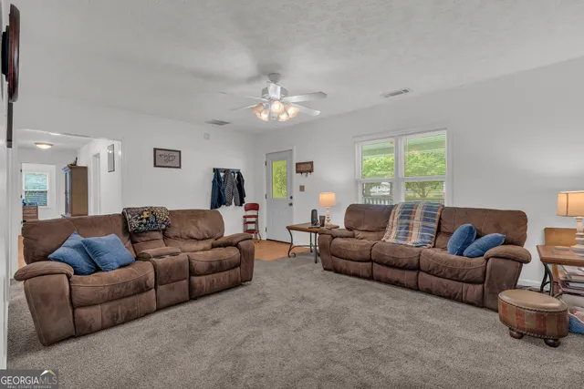 a living room with furniture and a lamp