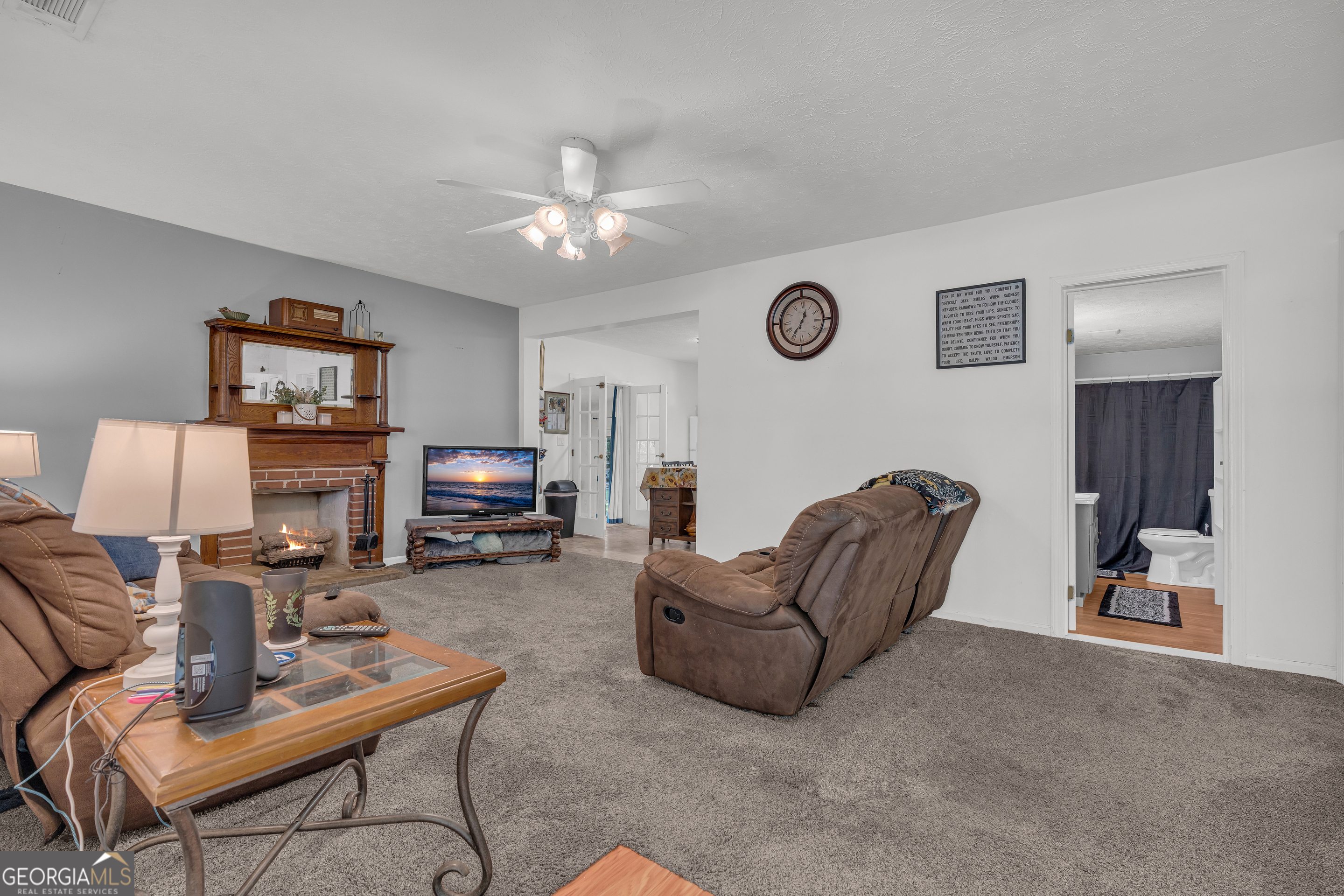878 Jackson Street Locust Grove, GA 30248 - Photo 16 of 65 a living room with furniture and a lamp