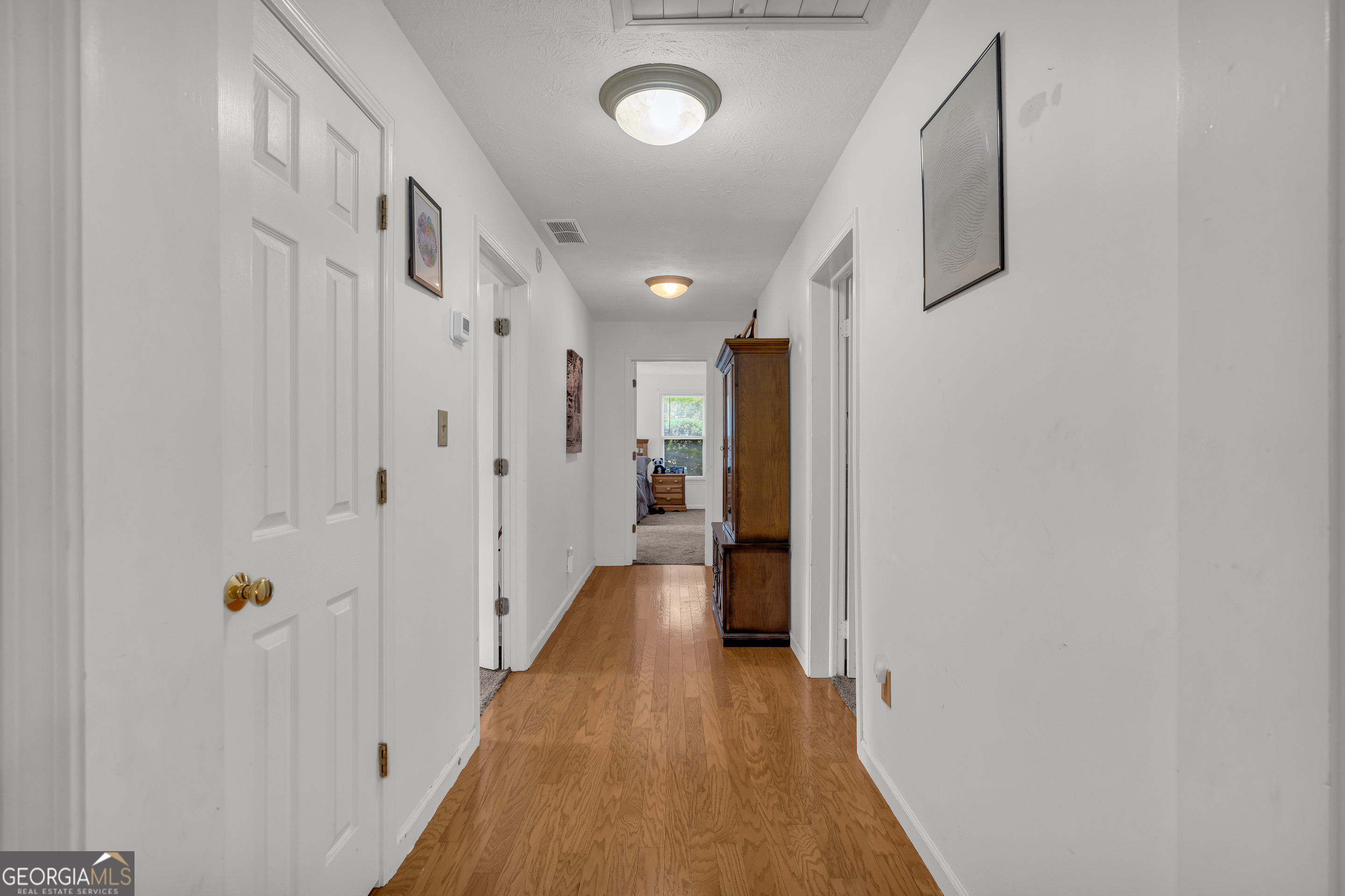 878 Jackson Street Locust Grove, GA 30248 - Photo 18 of 65 a view of a hallway with wooden floor and staircase