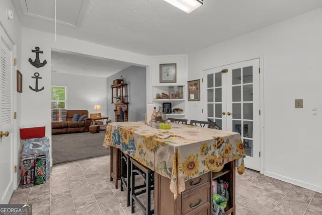 a kitchen with granite countertop a sink stove and cabinets
