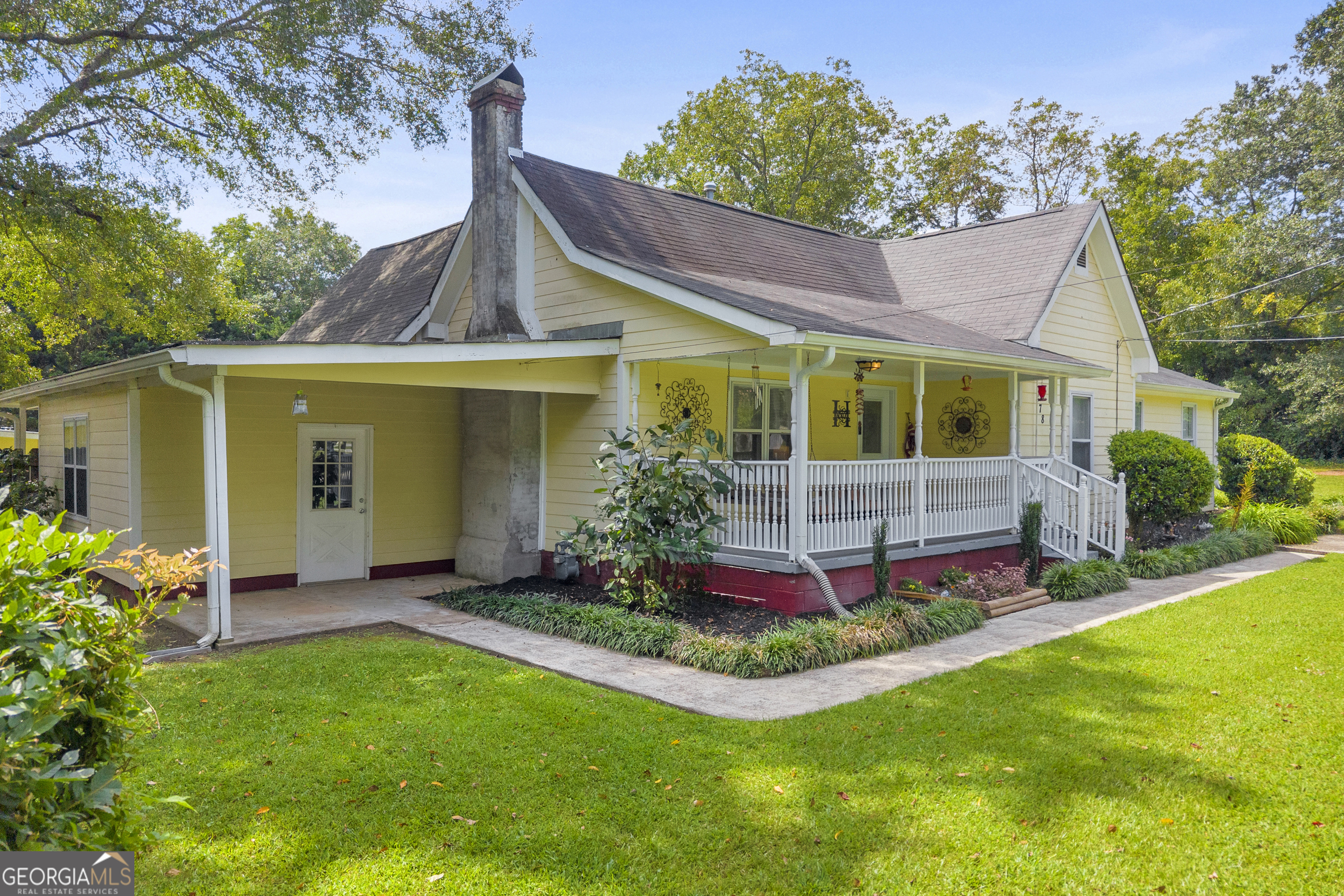 878 Jackson Street Locust Grove, GA 30248 - Photo 2 of 65 a view of a house with a yard and potted plants