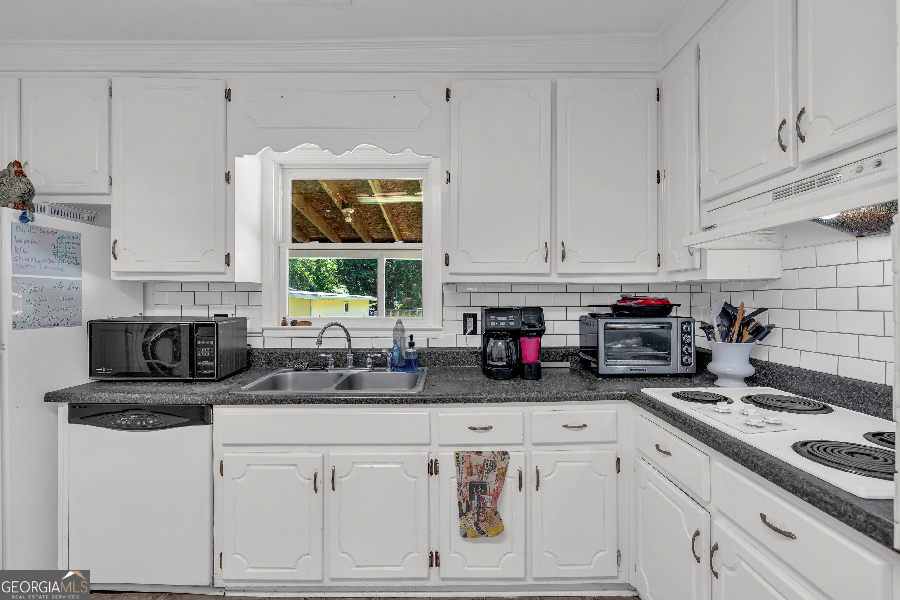 878 Jackson Street Locust Grove, GA 30248 - Photo 22 of 65 a kitchen with stainless steel appliances granite countertop a sink stove and cabinets