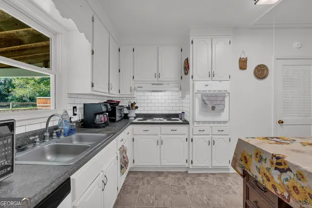 a view of a livingroom with furniture and an window