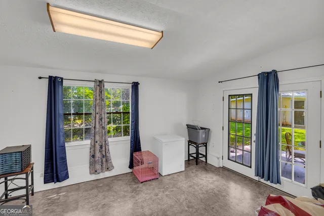 a view of a hallway with wooden floor and closet