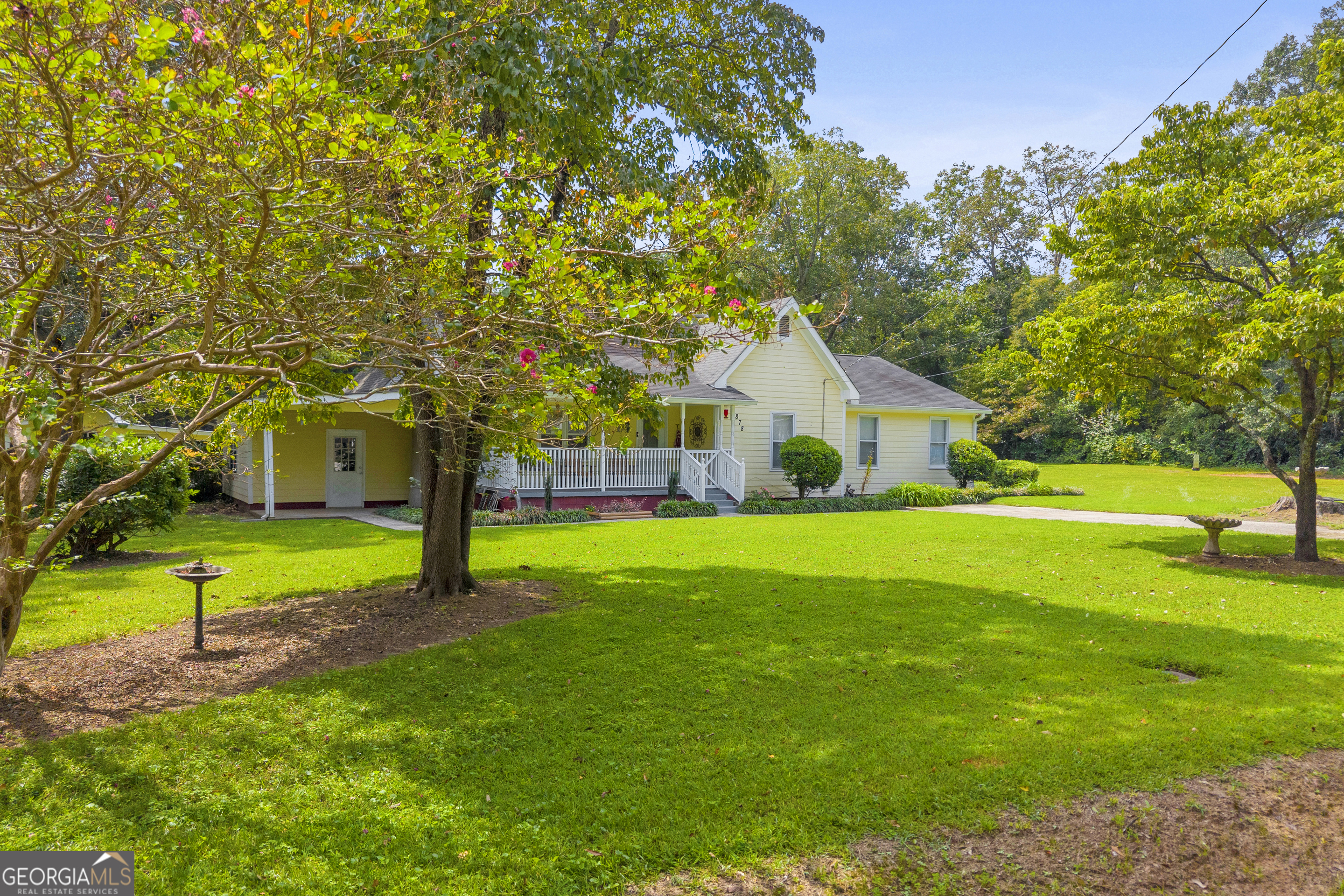 878 Jackson Street Locust Grove, GA 30248 - Photo 3 of 65 a front view of a house with garden and trees