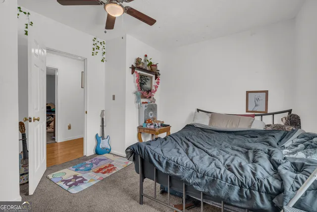 a bedroom with furniture and a flat screen tv