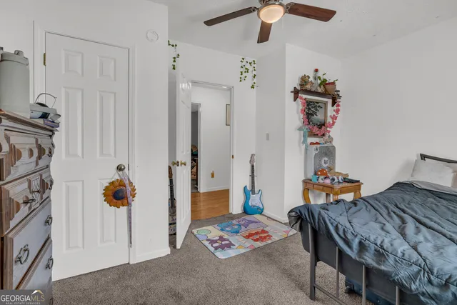 a bedroom with a bed and a tv on the dresser